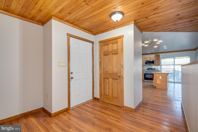 entrance foyer featuring light hardwood / wood-style floors, wooden ceiling, and ornamental molding