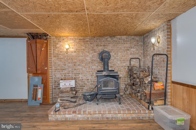 details with wood-type flooring, a wood stove, and wood walls