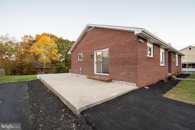 view of side of property featuring a patio area