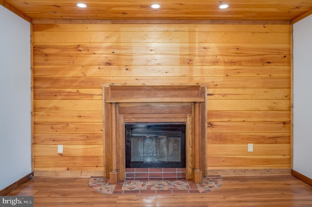 room details with wood walls, hardwood / wood-style floors, and wood ceiling