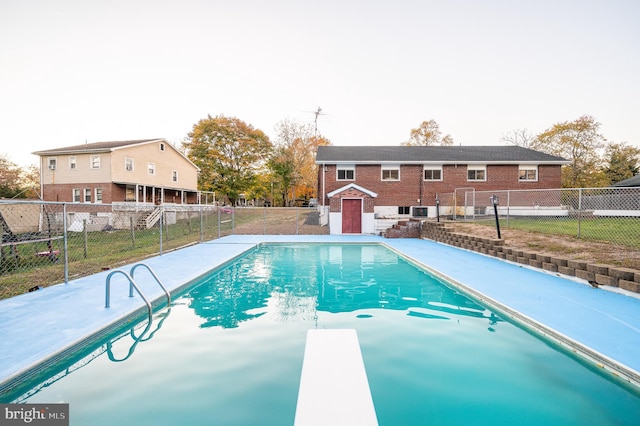 view of swimming pool with a yard and a shed