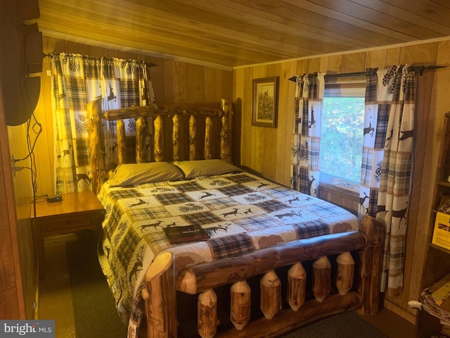 bedroom with wooden walls and wood ceiling