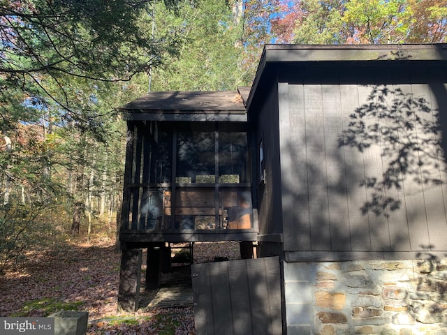 view of outbuilding featuring a sunroom