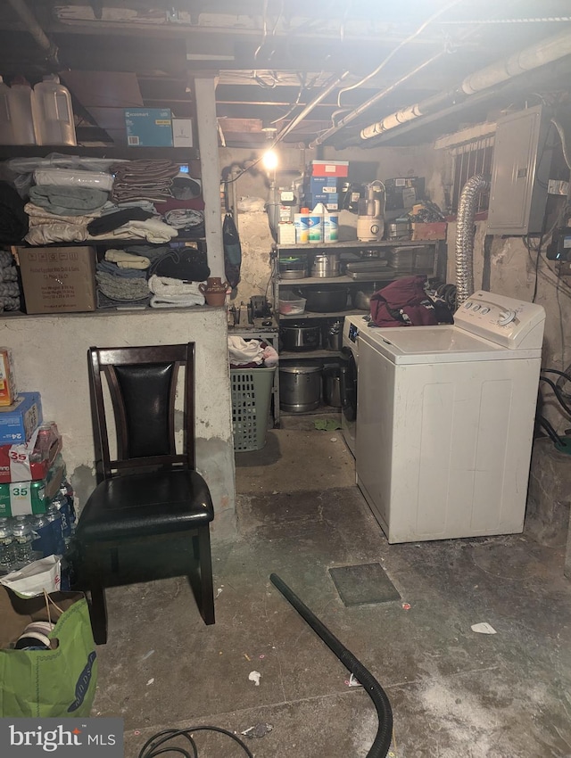 basement with electric panel and washer / clothes dryer