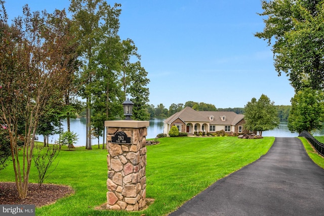 view of front of house with a water view and a front yard