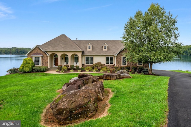 view of front facade with a water view and a front yard