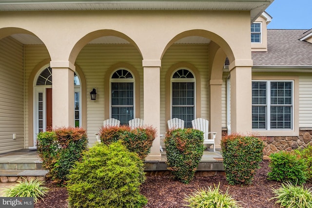 view of exterior entry featuring covered porch