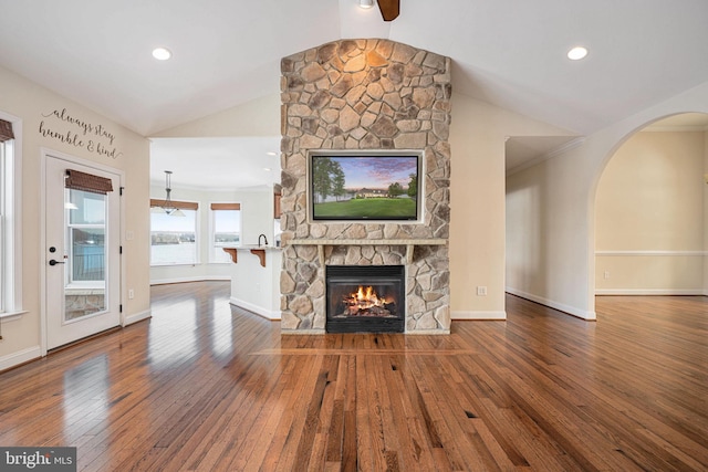 unfurnished living room featuring a fireplace, hardwood / wood-style flooring, and vaulted ceiling