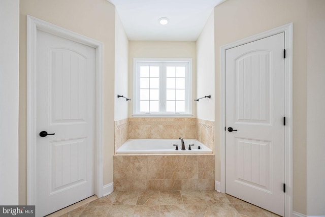 bathroom with tiled bath