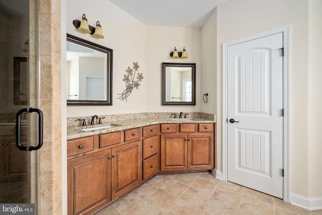 bathroom with vanity, tile patterned floors, and a shower with shower door