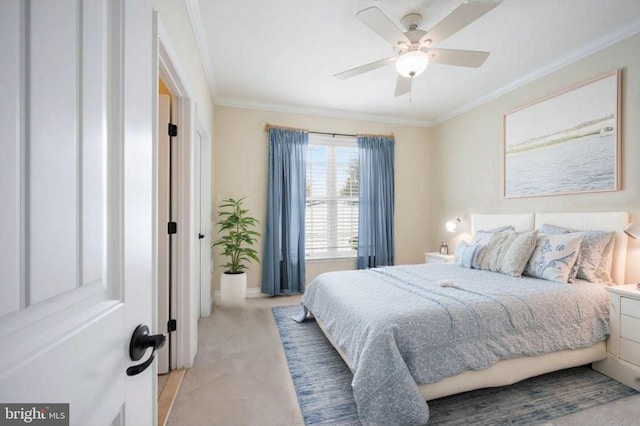 carpeted bedroom featuring ceiling fan and crown molding