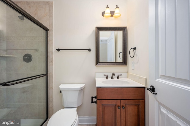 bathroom with vanity, toilet, and walk in shower