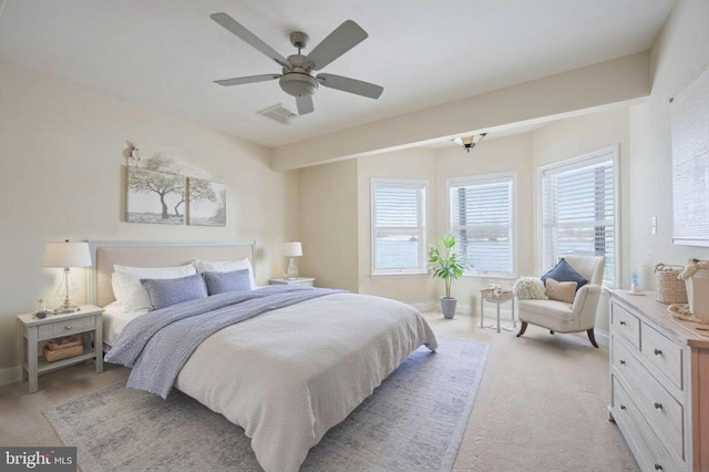 bedroom featuring ceiling fan and light carpet