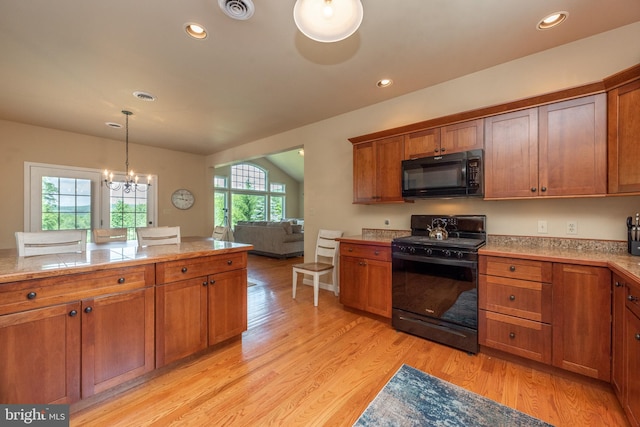 kitchen with black appliances, light hardwood / wood-style flooring, and plenty of natural light