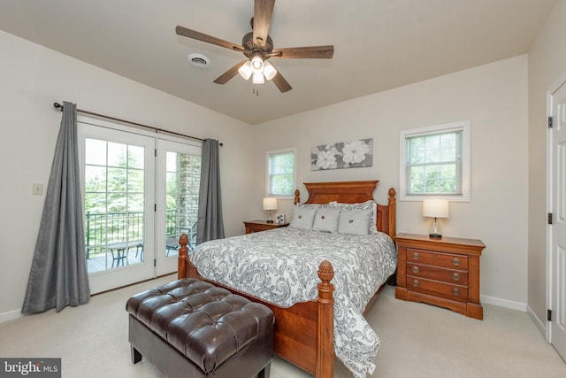 bedroom with access to outside, multiple windows, light colored carpet, and ceiling fan