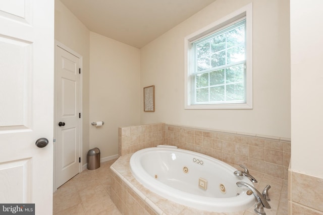 bathroom featuring a relaxing tiled tub and tile patterned floors