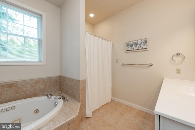 bathroom featuring vanity, tiled tub, and tile patterned flooring