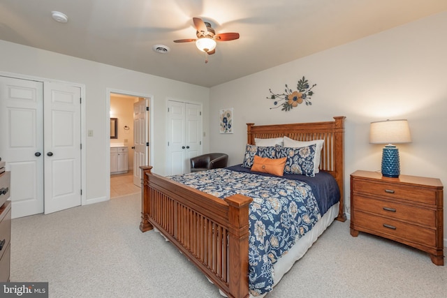 428 Pinnacle Dr, Swanton, MD 21561 - bedroom featuring visible vents, connected bathroom, a ceiling fan, and light carpet