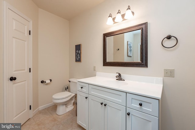 bathroom featuring toilet, vanity, and tile patterned floors