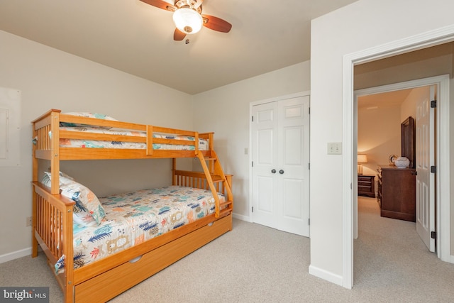 carpeted bedroom featuring a closet and ceiling fan