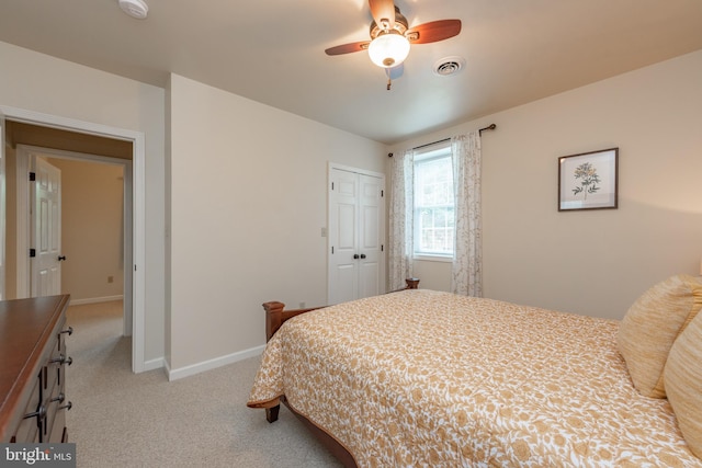 bedroom featuring a closet, ceiling fan, and light carpet