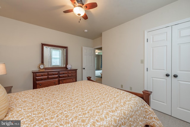 carpeted bedroom featuring a closet and ceiling fan