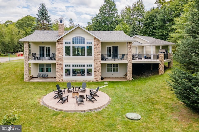 428 Pinnacle Dr, Swanton, MD 21561 - rear view of house with a fire pit, a balcony, a chimney, a patio area, and a yard
