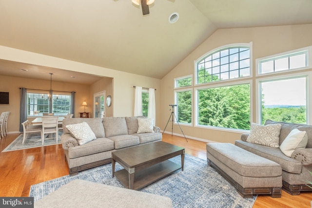428 Pinnacle Dr, Swanton, MD 21561 - living area featuring wood finished floors, ceiling fan, baseboards, visible vents, and high vaulted ceiling