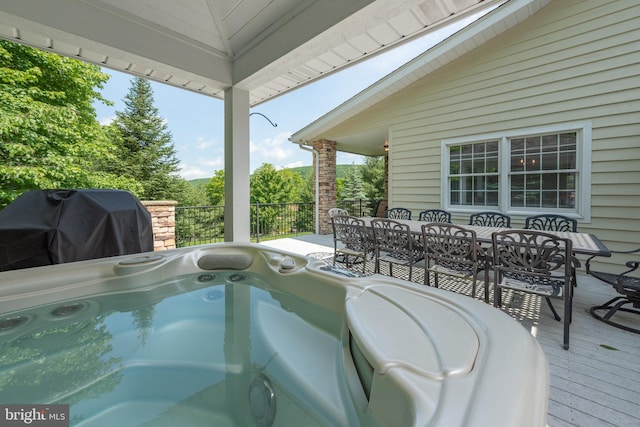 exterior space with a hot tub, area for grilling, and a wooden deck