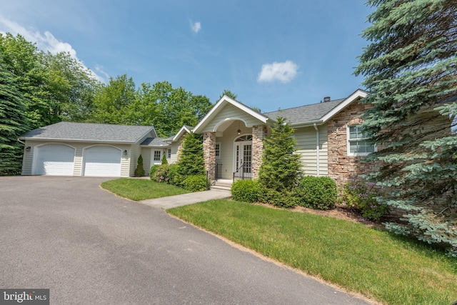 428 Pinnacle Dr, Swanton, MD 21561 - ranch-style house with a front yard, driveway, stone siding, and a garage