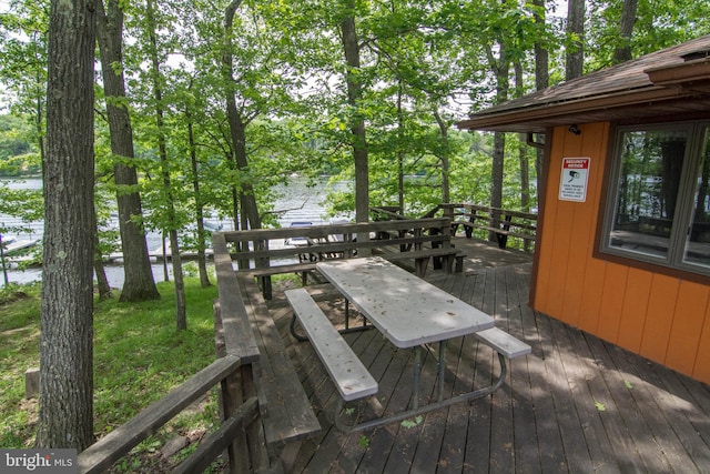 wooden terrace featuring a water view