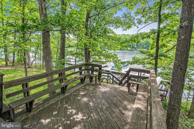 wooden terrace featuring a water view