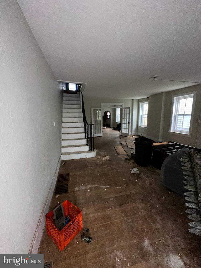 interior space with visible vents, baseboards, and stairs