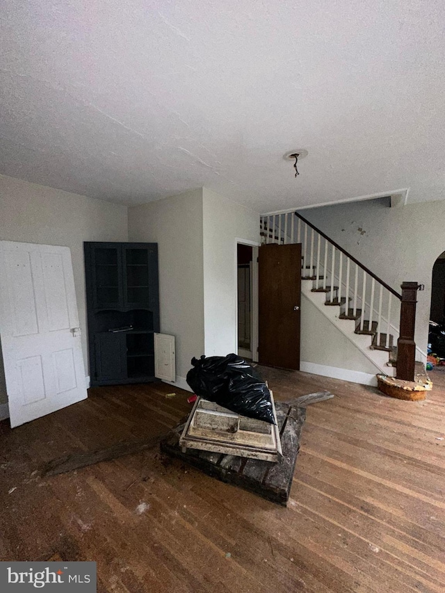 living room featuring hardwood / wood-style floors and a textured ceiling