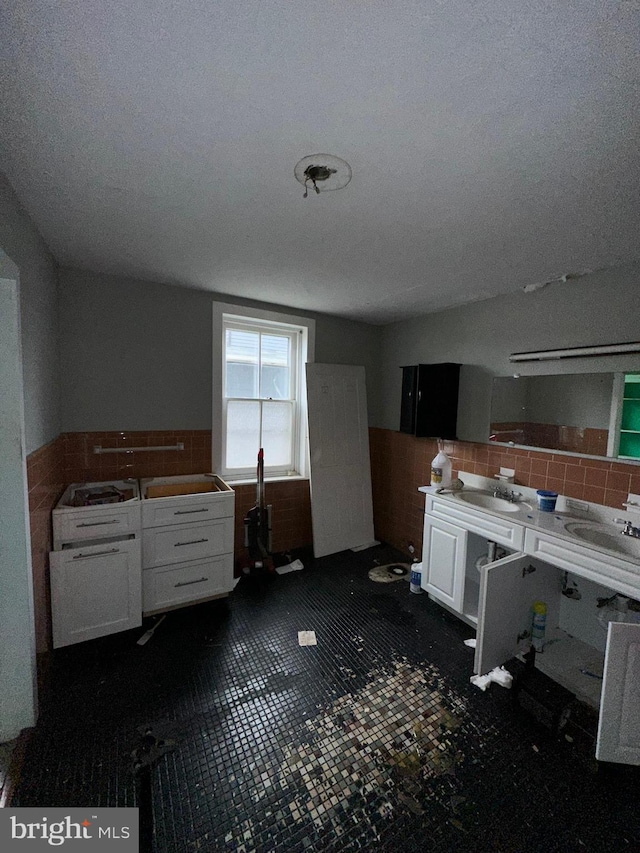 kitchen with white cabinets and a textured ceiling