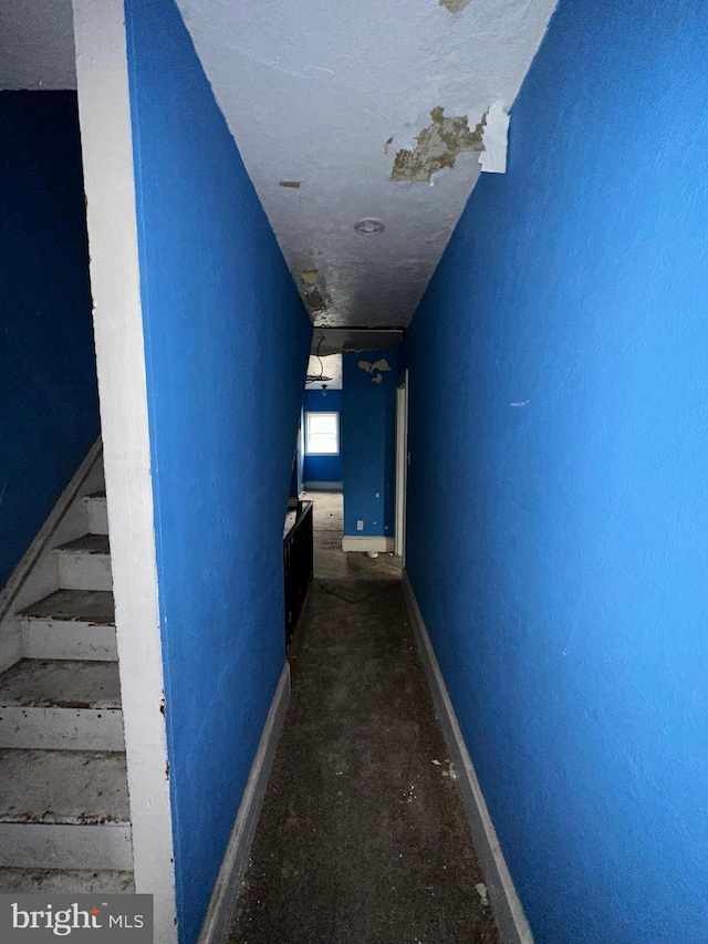 hallway with a textured ceiling