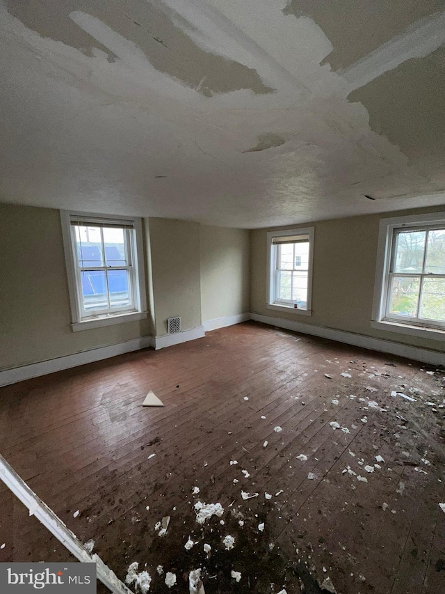 empty room featuring a textured ceiling and hardwood / wood-style flooring