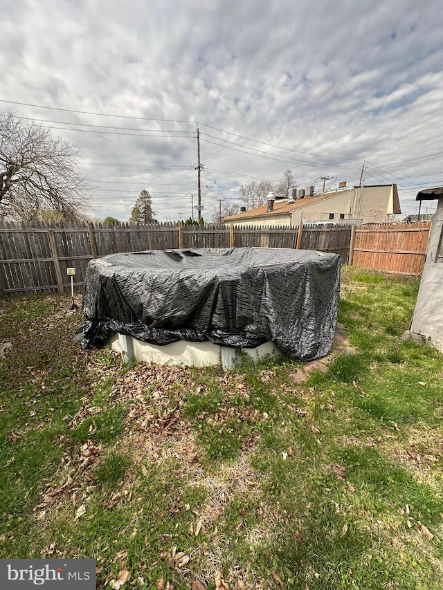 view of yard featuring a fenced in pool and a fenced backyard