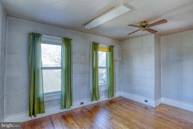 unfurnished room featuring ceiling fan and light wood-type flooring