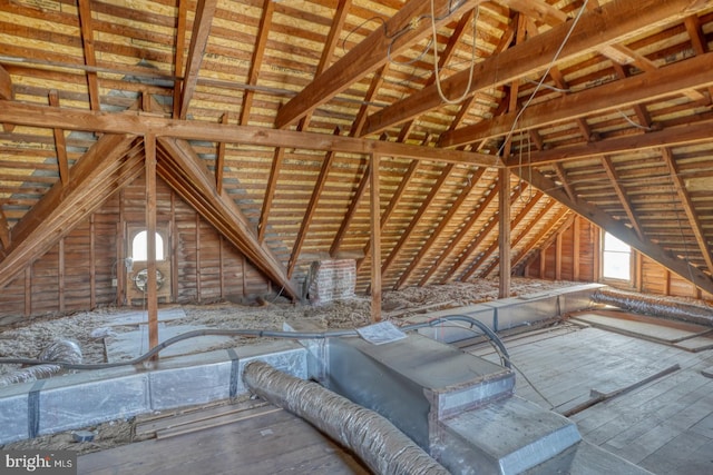 unfinished attic featuring plenty of natural light