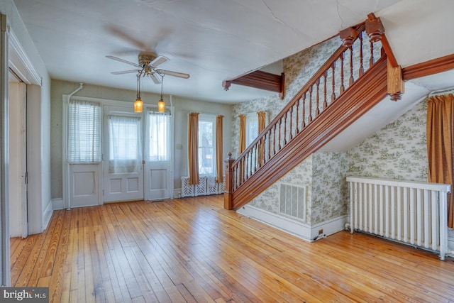 entryway featuring radiator, ceiling fan, and wood-type flooring