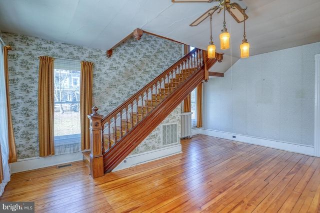 unfurnished living room featuring lofted ceiling and light wood-type flooring