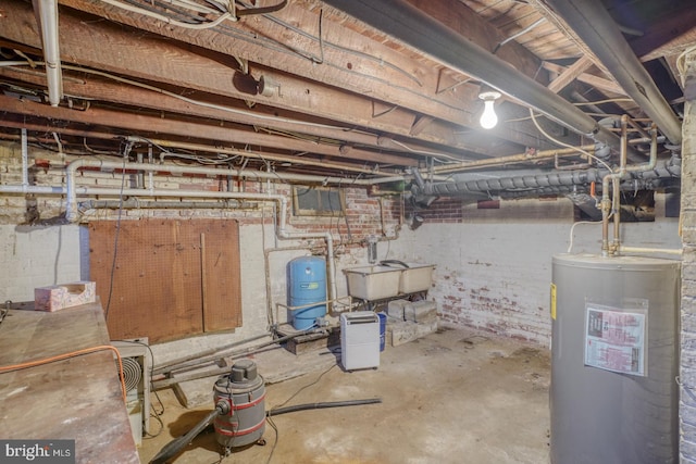 basement featuring water heater and sink