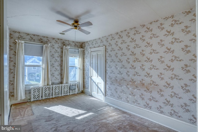 carpeted spare room with ceiling fan