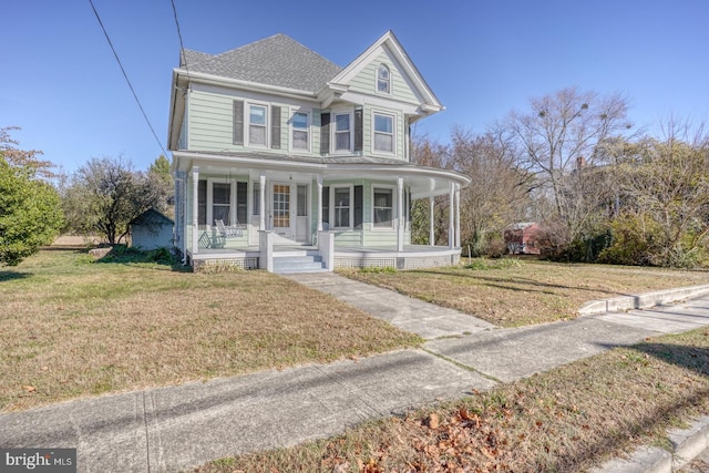 view of front facade featuring covered porch and a front yard