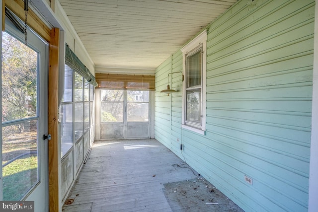 unfurnished sunroom featuring wood ceiling