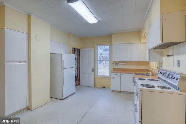 kitchen featuring white appliances, white cabinetry, and sink