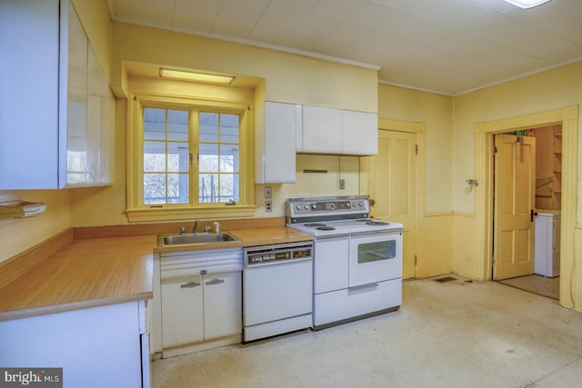 kitchen with white cabinets, white appliances, ornamental molding, and sink