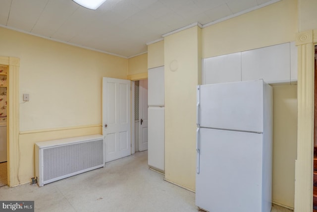 kitchen featuring white fridge and radiator heating unit