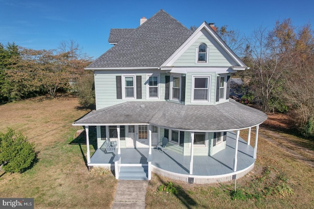 view of front of property featuring a front lawn and covered porch